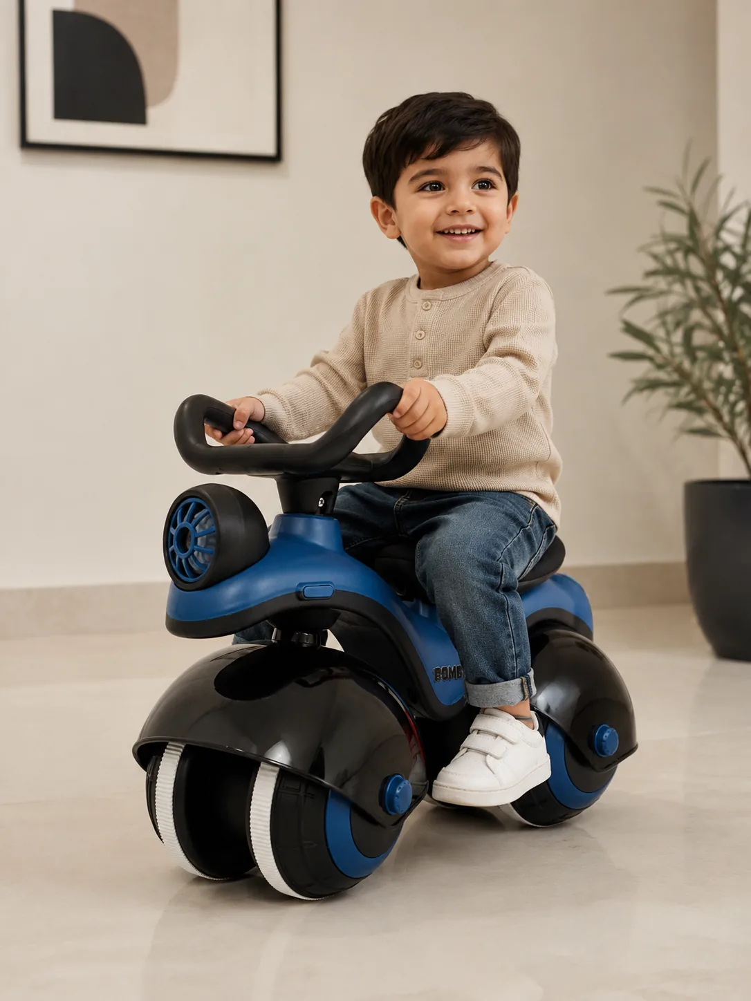 A smiling toddler riding the blue Bomby at home