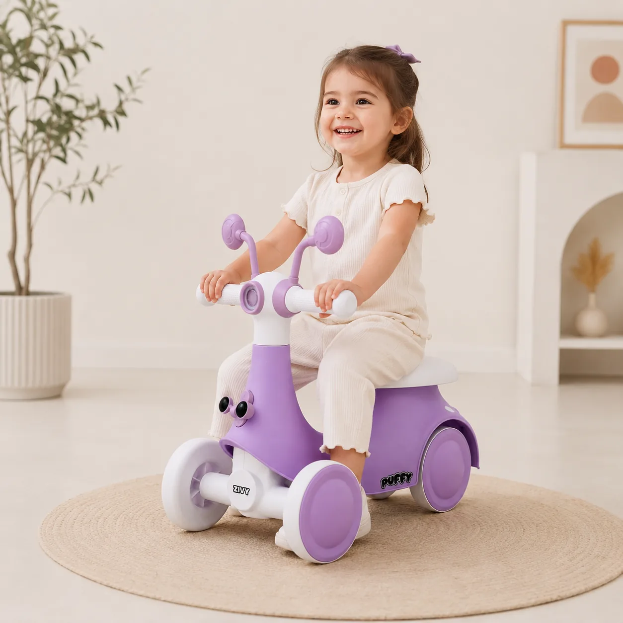 A happy toddler steering the purple Puffy Rider